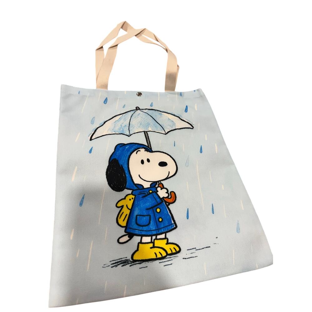 Snoopy canvas tote bag with blue raincoat and umbrella snap closure